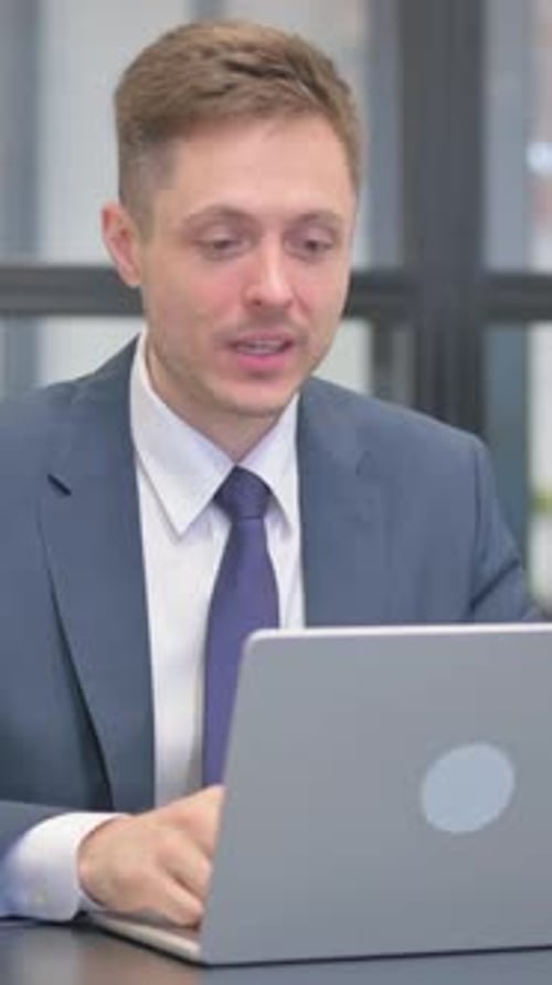 Man in Suit Working on Laptop Computer