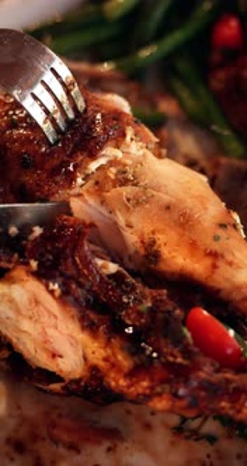 Knife, fork and cut turkey in home with vegetables for Christmas dinner