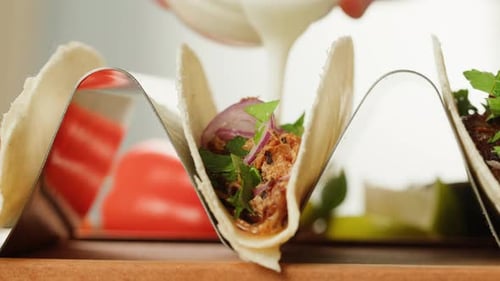 Close-up of Taco Shells Being Filled