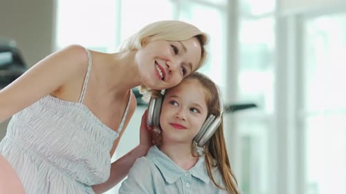 Woman and Child Bonding While Listening to Music