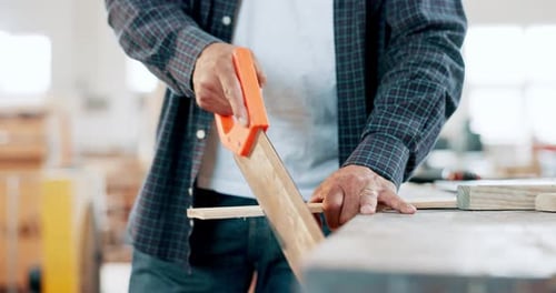 Wood, carpenter and hands in workshop with saw, tools and construction process in garage closeup