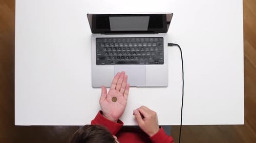Top View Freelancer Flipping Coin While Working From Home Office
