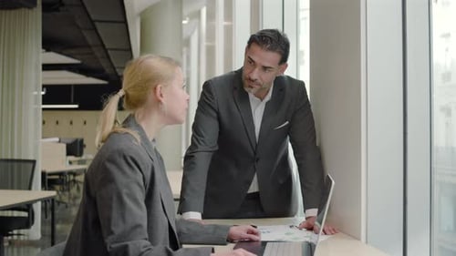 Business Professionals Engaging in Dynamic Collaboration Within a Modern Office Environment