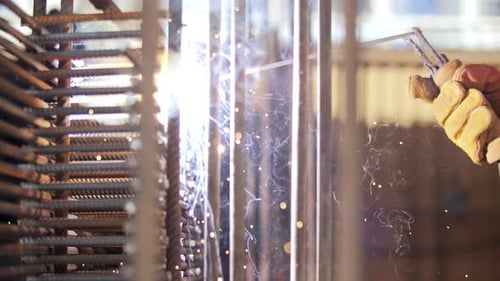 Person Welding Metal Structure With Sparks