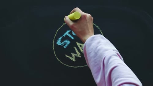 Timelapse A Child Hand Drawing a Planet a House Flowers and Trees on a Chalkboard with Yellow and
