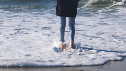 Woman or Girl Walks Along the Shore of the Atlantic Ocean