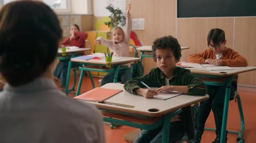 Group of Multiracial Little Pupils Children in School Class Lesson Listening Tutor Teacher Woman