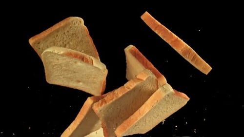 Slices of Toast Bread Falling on Black Background
