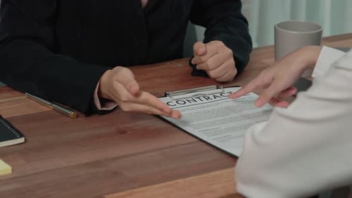 Business Professionals Reviewing a Contract in Modern Office