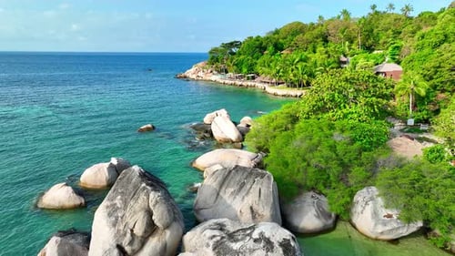 Rocky coastline with green forests and unique blue turquoise sea water.