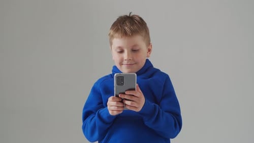Portrait of Happy Smiling Boy in Blue Tshirt Attractive Kid in Studio Over Grey