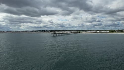 Slowly flying away drone shot from the Bogue Inlet Pier, Emerald Isle NC