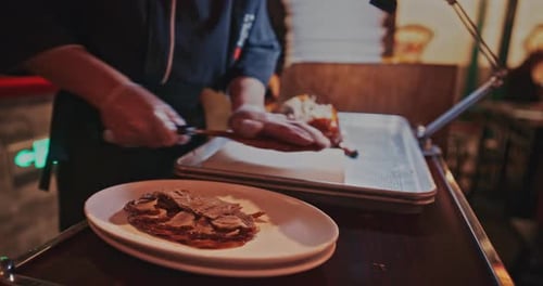 Chef slicing roasted duck meat in the restaurant