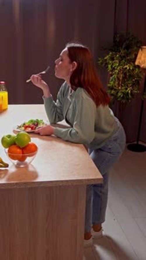 Woman Eats Dinner at Kitchen Counter