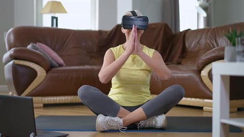 Senior Woman Using VR Headset for Home Fitness