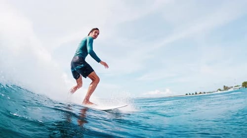 Surfer rides the ocean wave in tropical Maldives