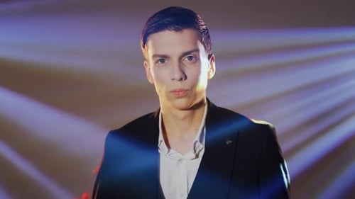 Portrait of a Young Caucasian Male Businessman or Groom in a Jacket and Shirt in the Rays of