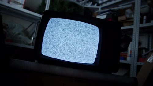 Vintage Television with Static in Cluttered Room