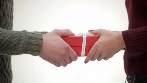 Close Up Male Hands Giving a Gift to Girl