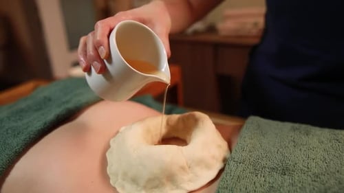 Ayurvedic massage for beautiful woman in spa