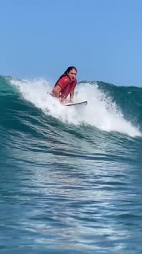Young Guy Surfs in the Ocean
