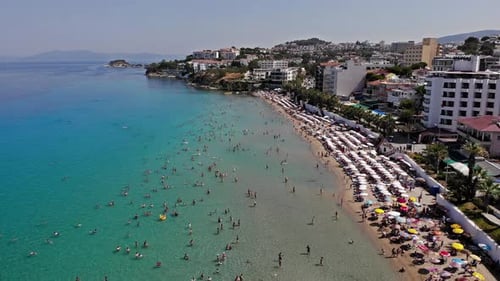 drone view of the coastline and people swimming in the sea