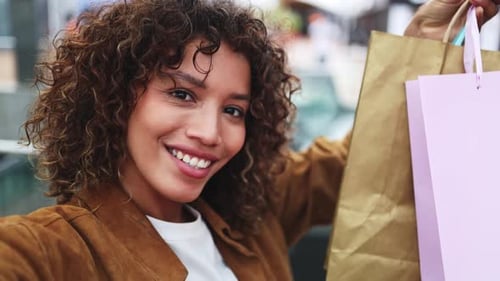 Enthusiastic shopper showing purchases in subway station
