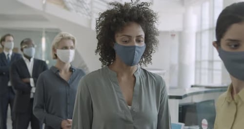 Temperature checkup in office entrance reception before entering office meeting