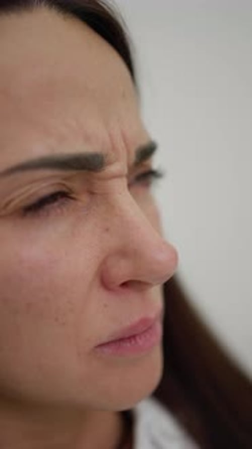 Woman Examining Facial Wrinkles Closeup of Woman's Face Showing Concern Over Forehead Wrinkles