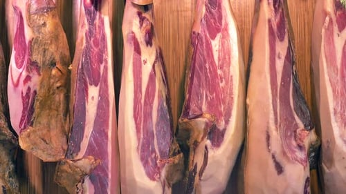 Dry-Cured Ham (Jamon) cuts in La Boqueria market, Barcelona - Dolly shot