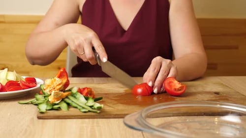 Woman Cutting Tomato on Cutting Board Close Up