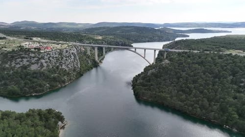 Drone flight above a beautiful arch bridge near the town of Shibenik in Croatia