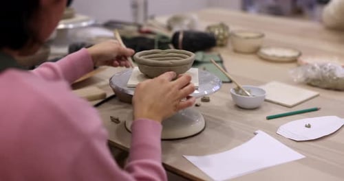 Creating clay bowl on pottery wheel