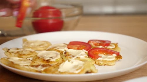 Pancakes with cream cheese and tomato on plate