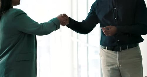 Business Handshake in Bright Modern Office