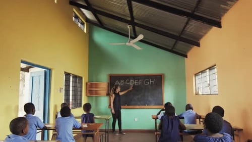 Back View of School Classroom of African Students Learning English Language