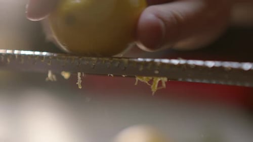 Person Zesting a Lemon in Close Up