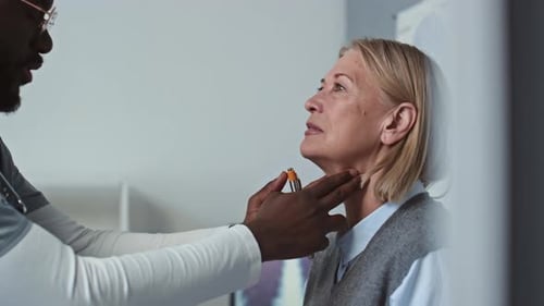 Doctor Examines Woman in Medical Office