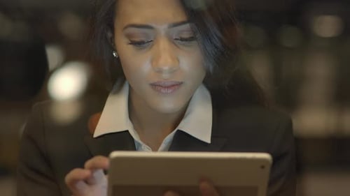 Business Woman Using Tablet at Night
