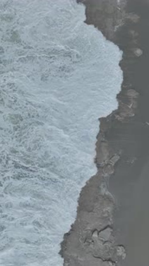 Vertical Video Aerial Perspective of Stormy Mediterranean Seas With Crashing Waves and Flying Foam