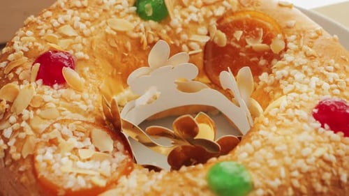 Un dulce pastel español, postre de Roscón de Reyes cubierto con almendras y fruta confitada