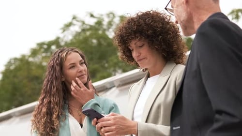 Business Professionals Talking with Phone Outdoors