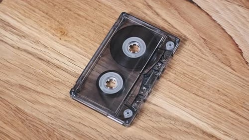 Vintage Audio Cassette Resting on Wooden Surface