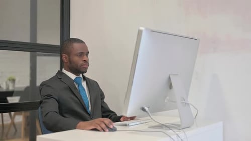Man Celebrates Success in Modern Office Workplace
