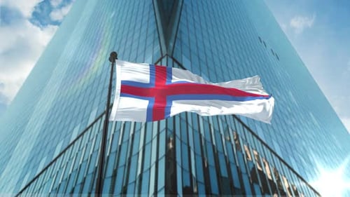 Waving Flag in Front of Modern Skyscraper
