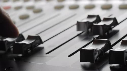 Digital audio console. Motorized sliders. Close up.