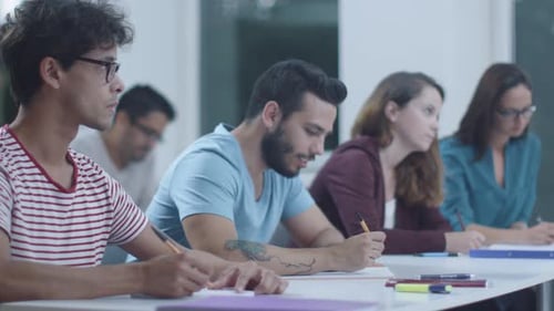 Students Writing in a Classroom in Daytime