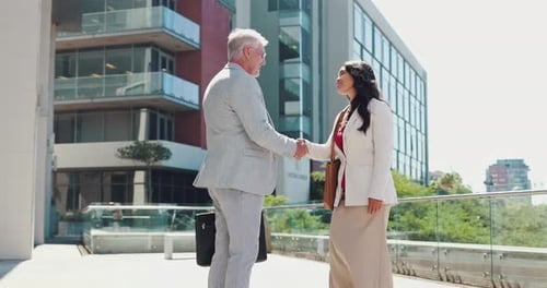 Business People Shaking Hands Outside Office Building