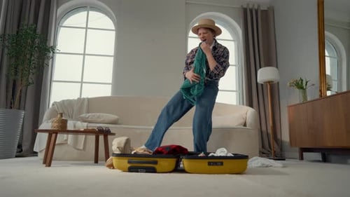Woman Packing Suitcase with Clothes for Travel