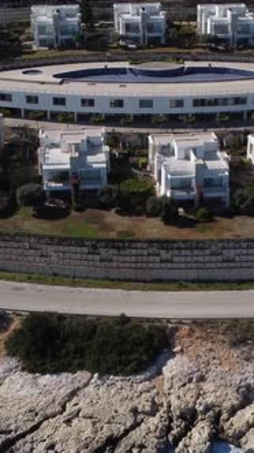 Drone Image Over White Holiday Homes and Sea